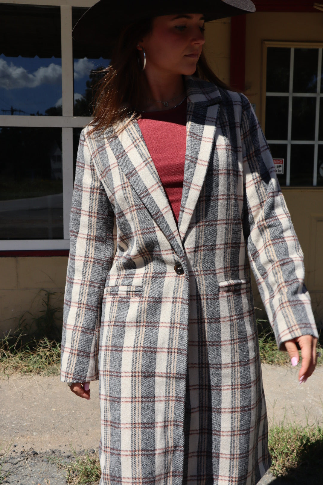 Person wearing a plaid coat with a blurred background